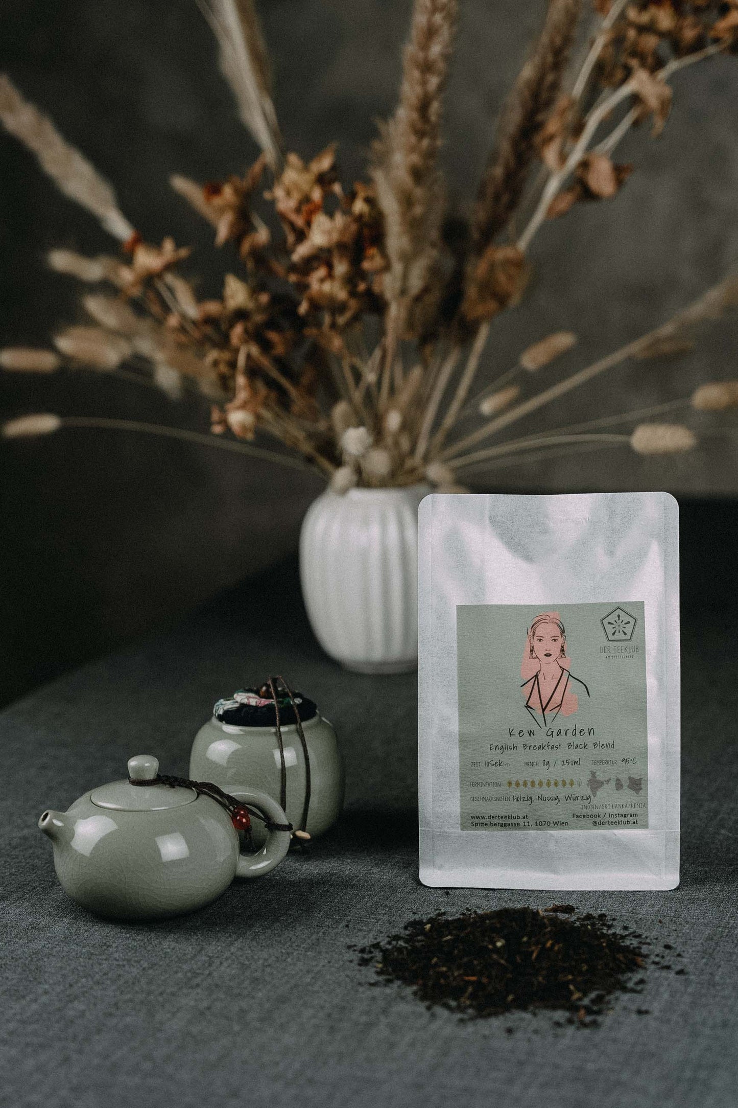 Teemischung Schwarztee auf grauem Tisch mit Kanne